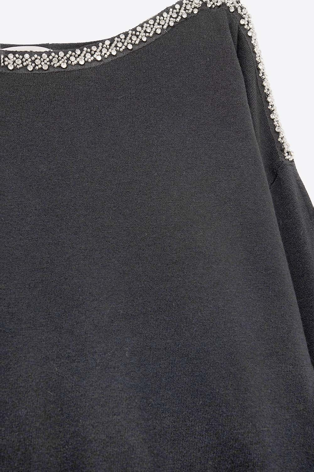 black fine knit sweater with a boat neck and rhinestone detail