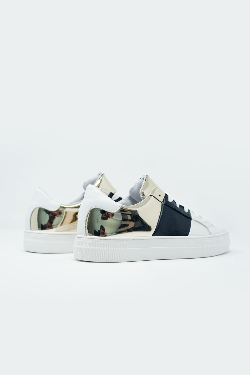 Dikke sneakers in zwart en goud