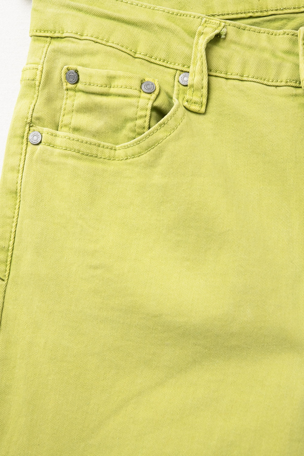 Flare jeans with raw hem edge in lime color