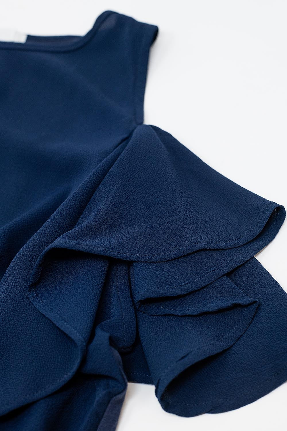 navy blue sleeveless top with ruffles