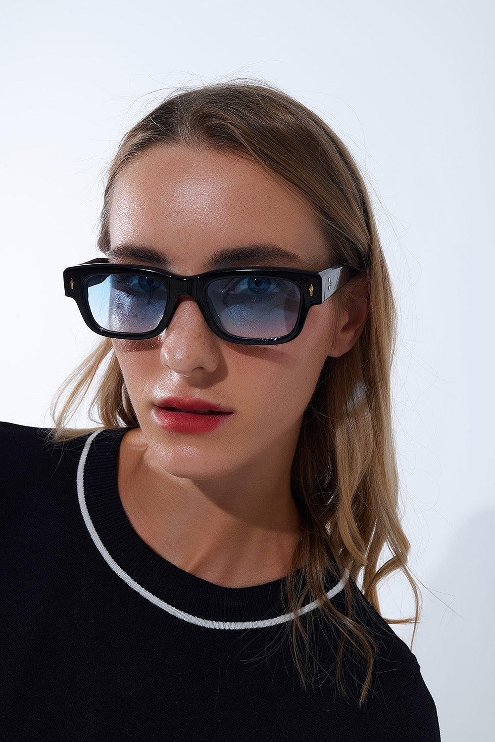 Óculos de sol pretos com armação oval com detalhe dourado e vidro azul