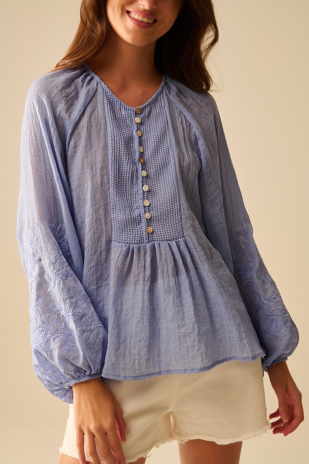 Blue chiffon blouse with embroidery on the sleeves