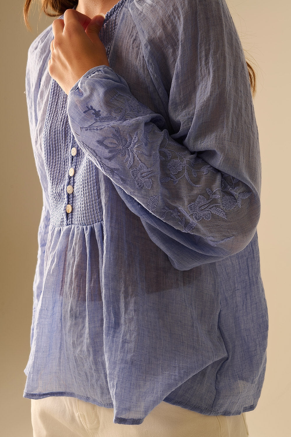 Blue chiffon blouse with embroidery on the sleeves