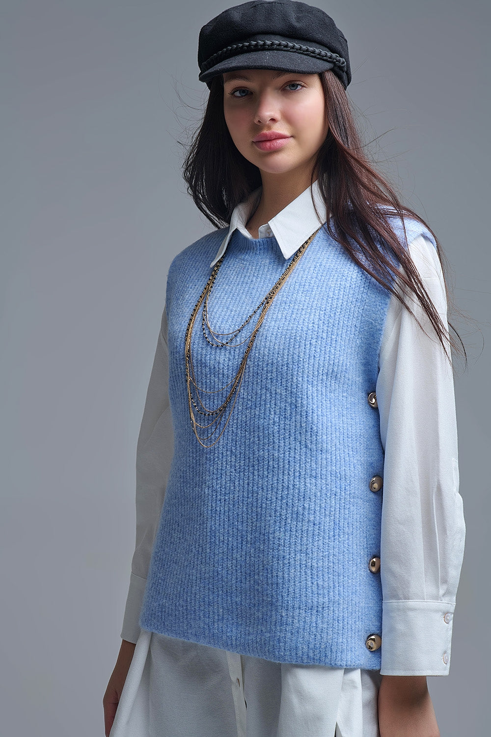 Blue sleeveless sweater with gold buttons on side