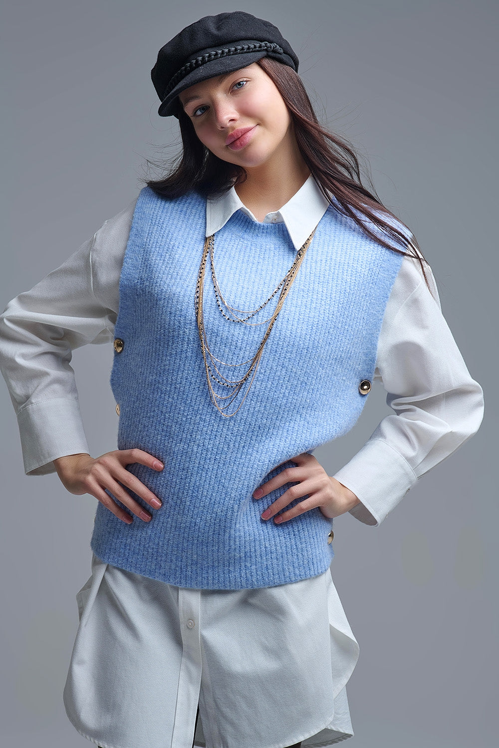Blue sleeveless sweater with gold buttons on side
