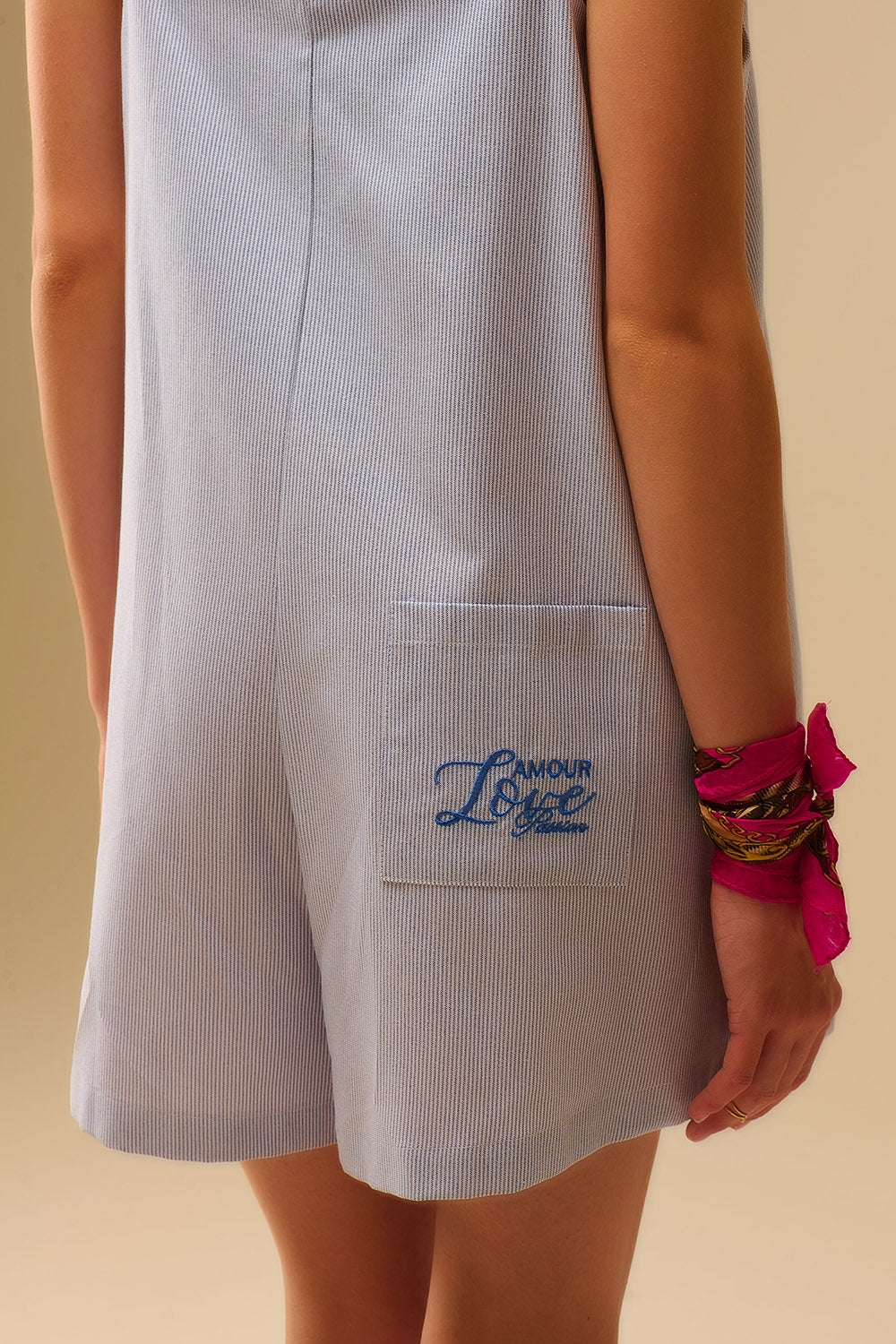 blue striped playsuit with shoulder ties and back pocket detail