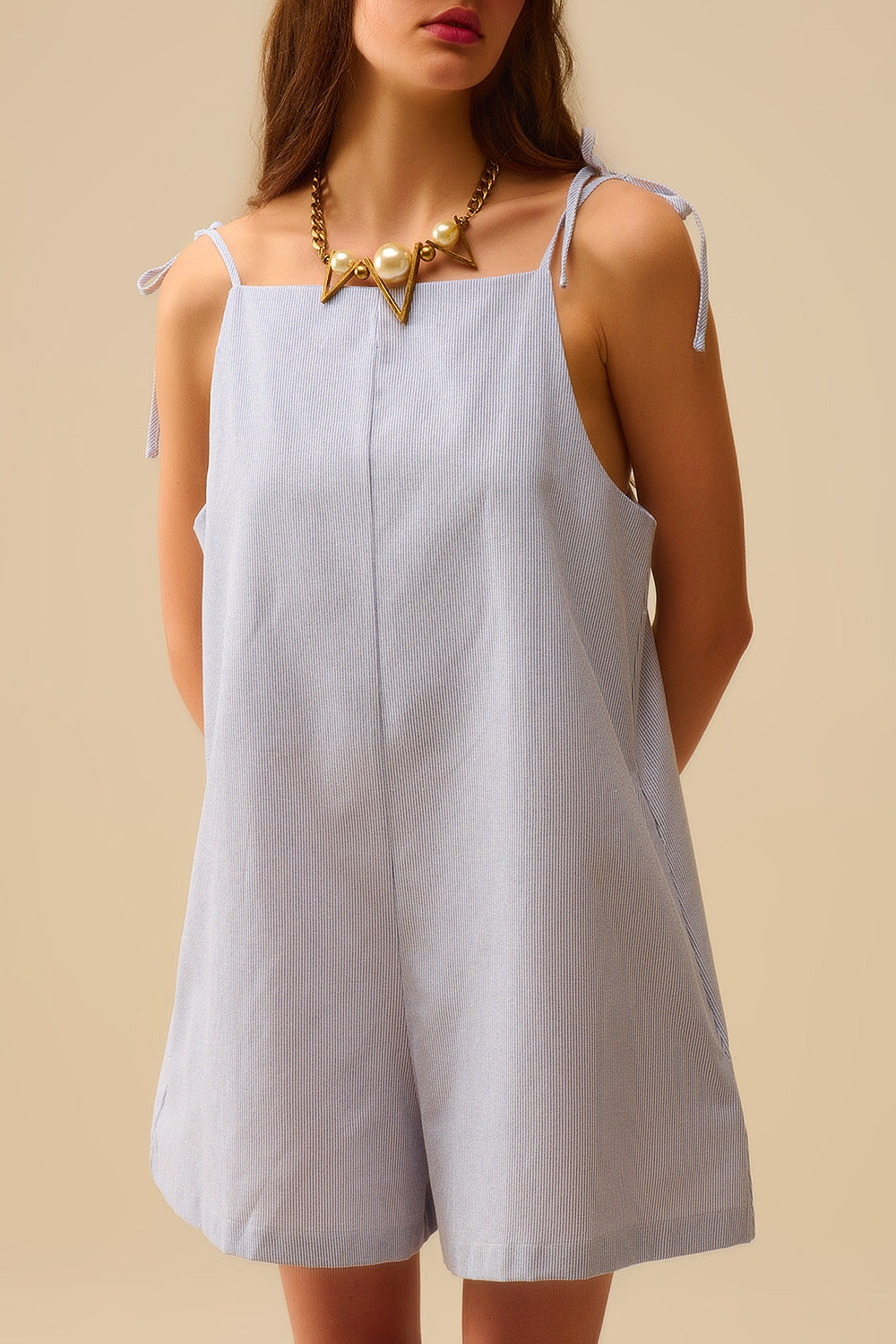 blue striped playsuit with shoulder ties and back pocket detail