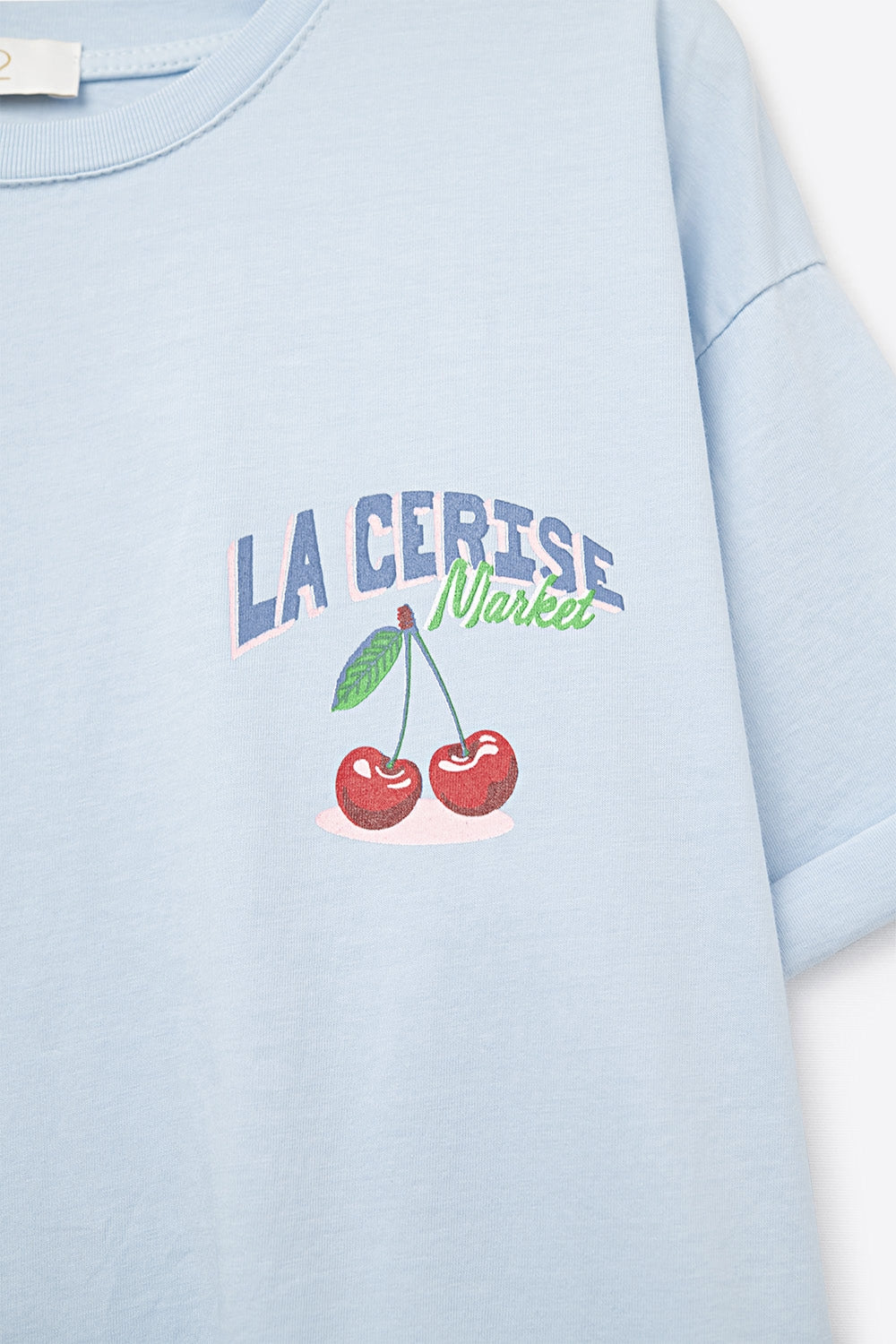 Blue T-shirt with La Cerise Market Saint-Tropez graphic