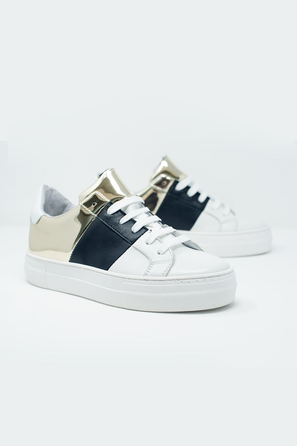 Dikke sneakers in zwart en goud