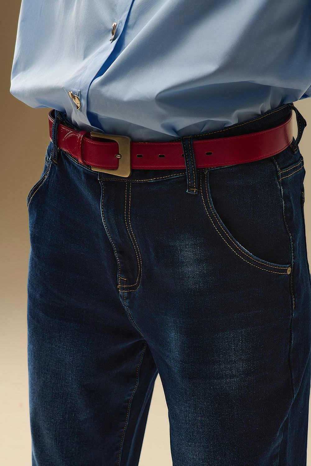 Dark wash jeans with contrast stitching and cuffed hems