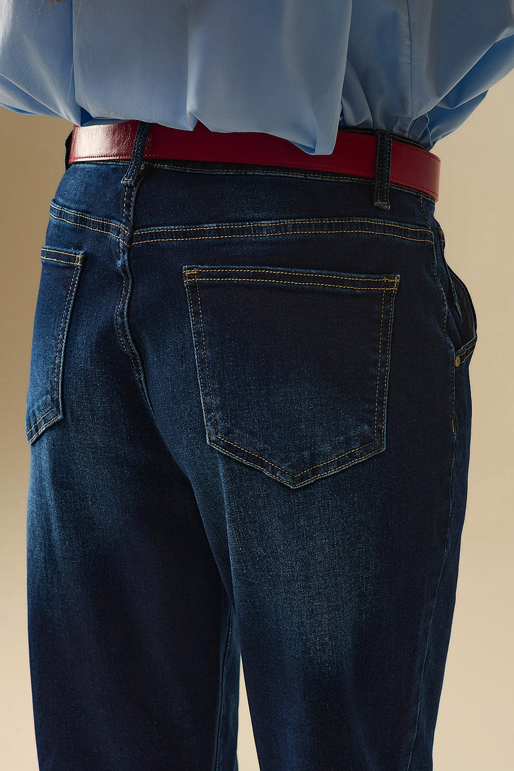 Dark wash jeans with contrast stitching and cuffed hems