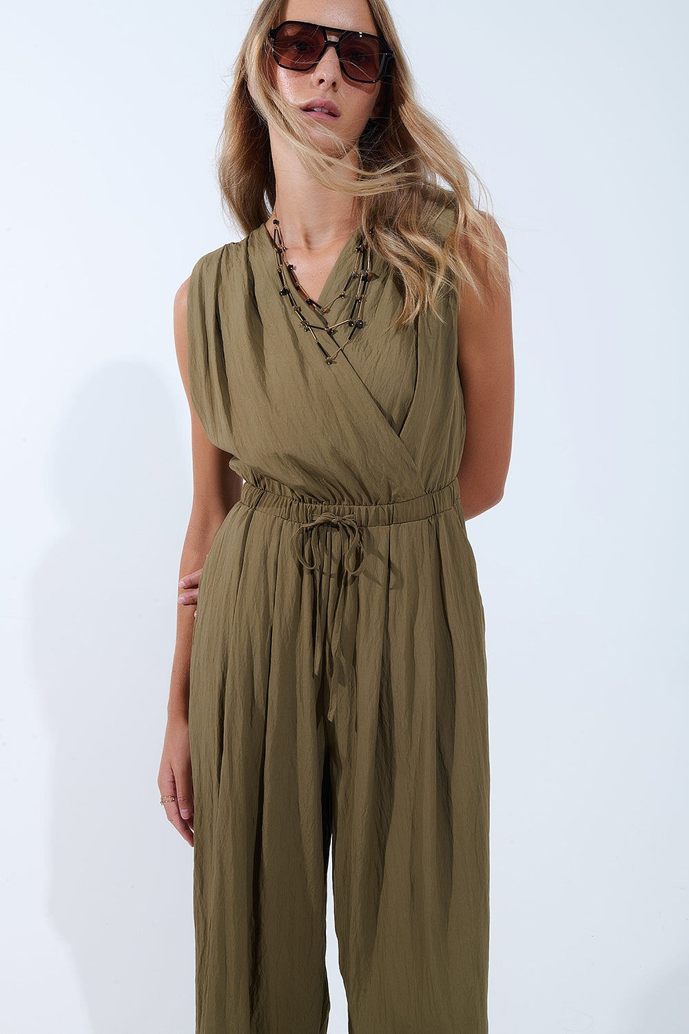 draped olive jumpsuit in crinkled fabric