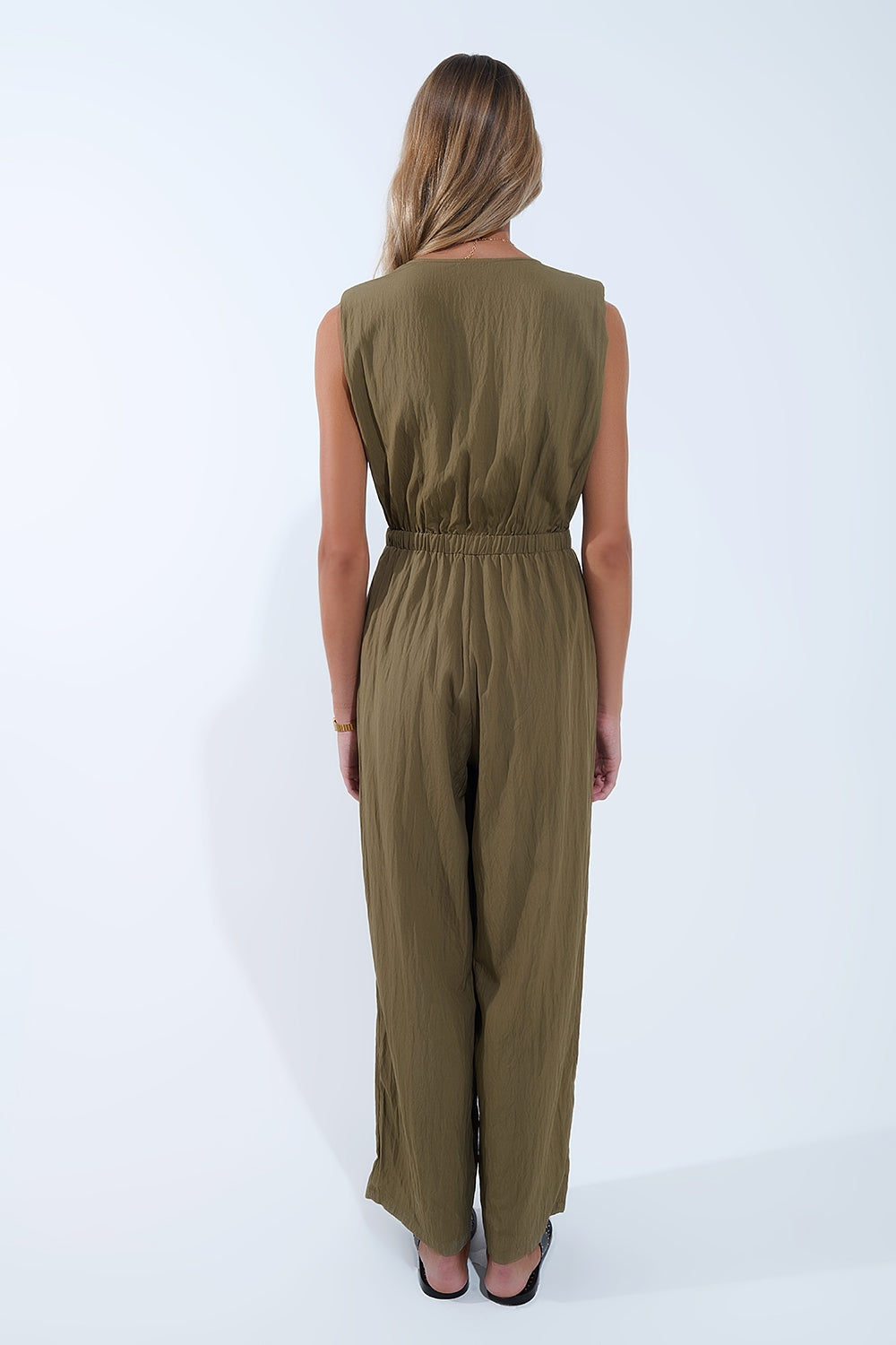 draped olive jumpsuit in crinkled fabric