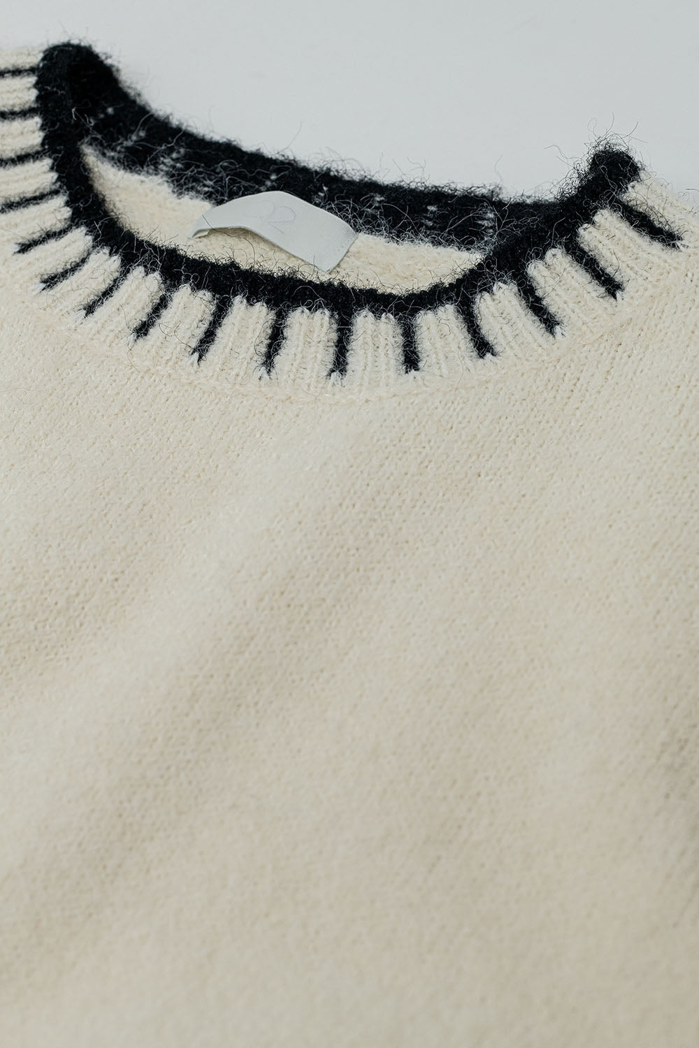 Fluffy cream sweater with ribbed detail at neck and hem