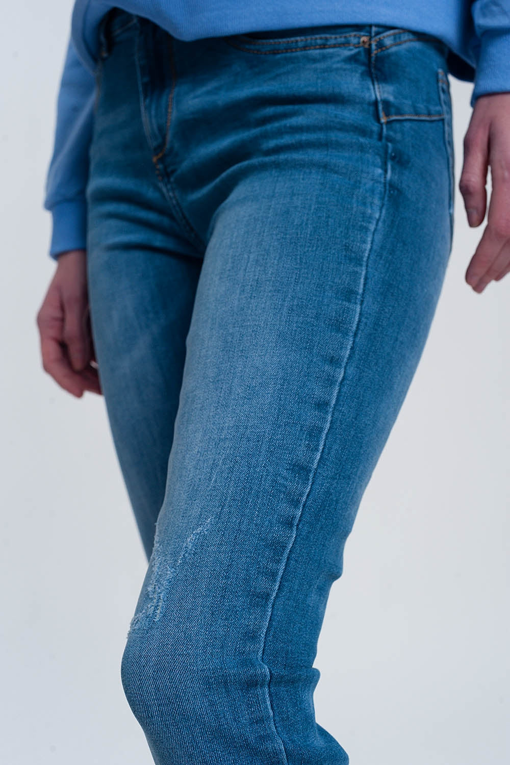 light denim skinny jeans with folded ankles and ripped detail