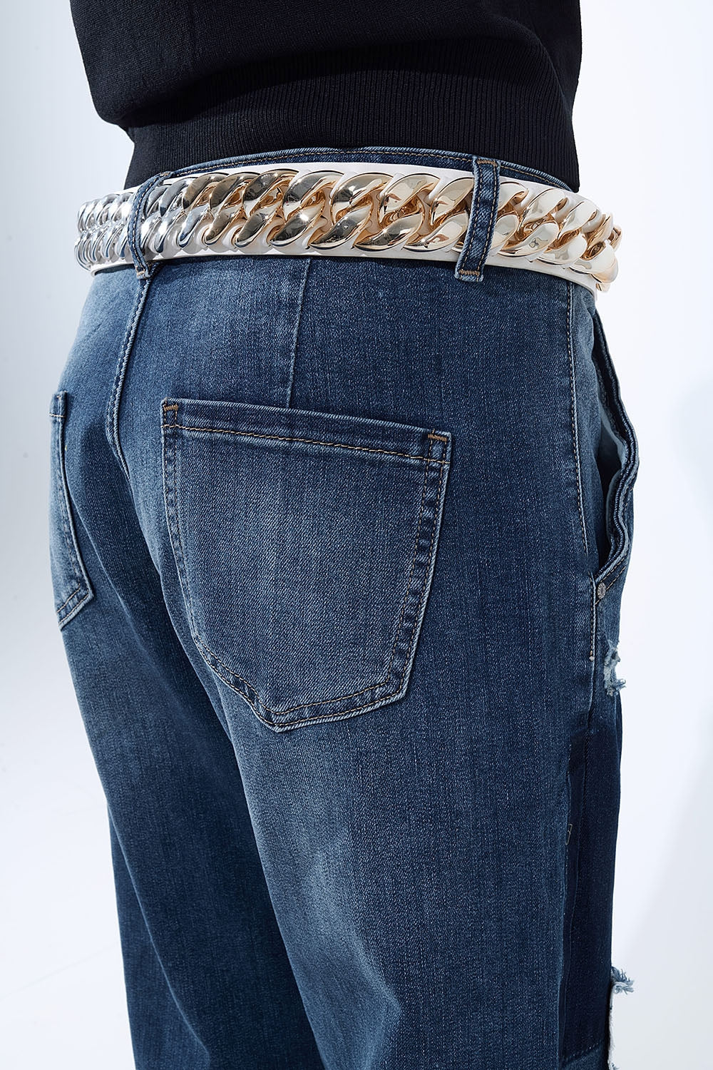 Loose-fitting jeans with distressed patches and paint details
