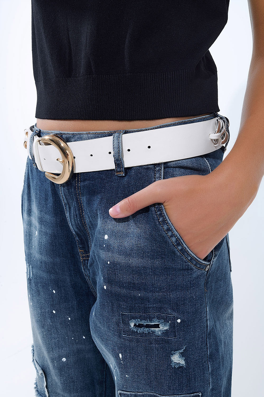 Loose-fitting jeans with distressed patches and paint details