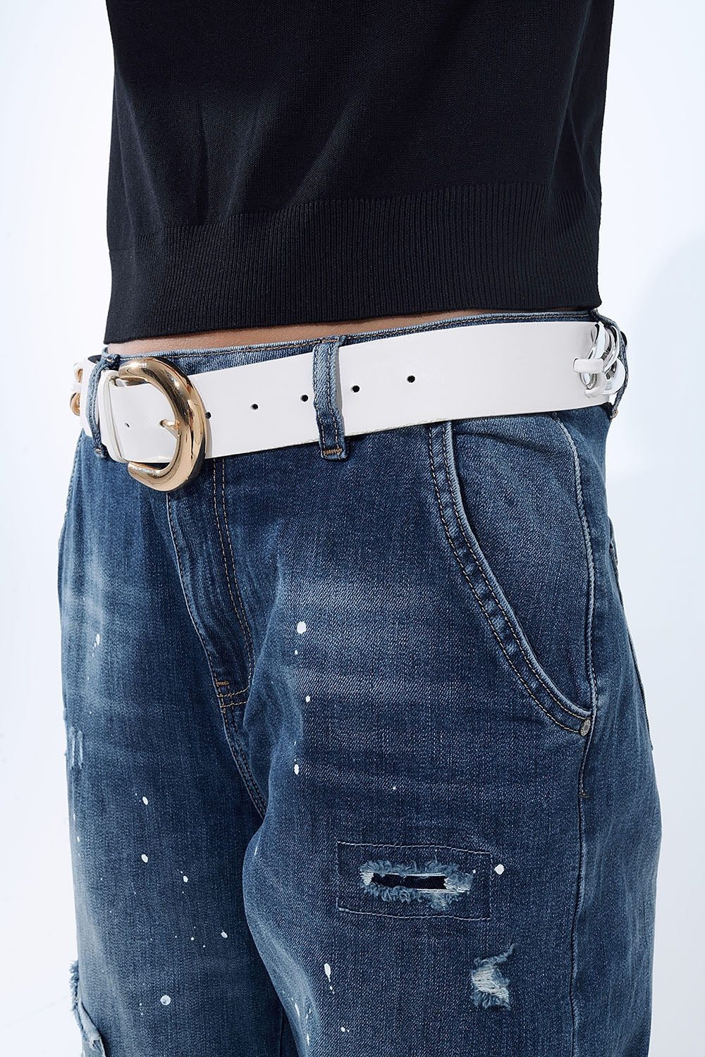 Loose-fitting jeans with distressed patches and paint details