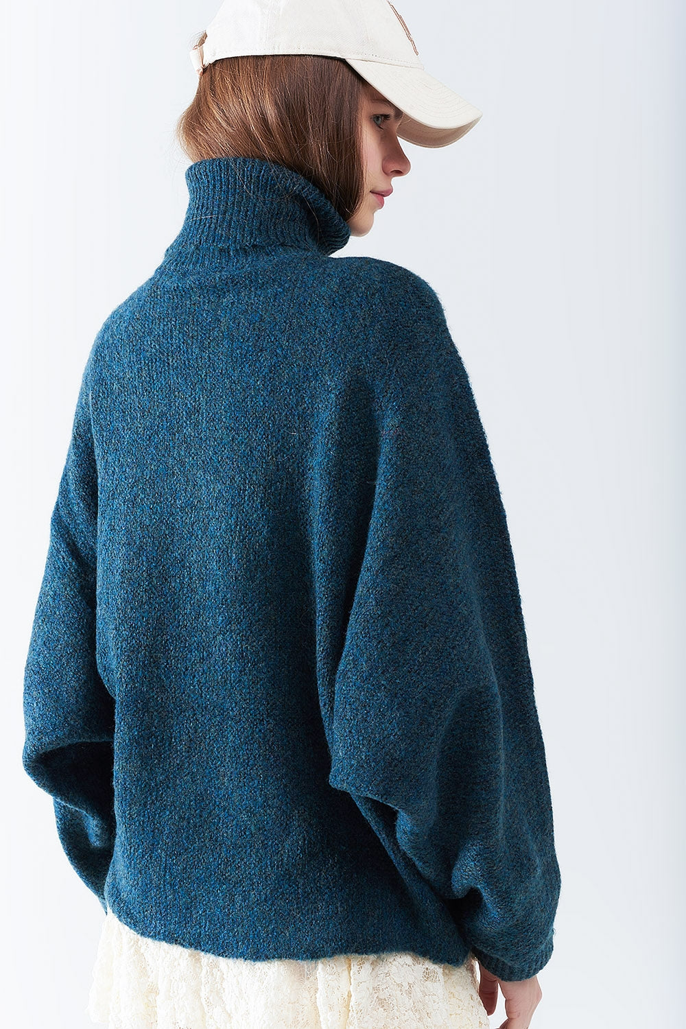 Oversized sweater in teal with a high neck and loose sleeves