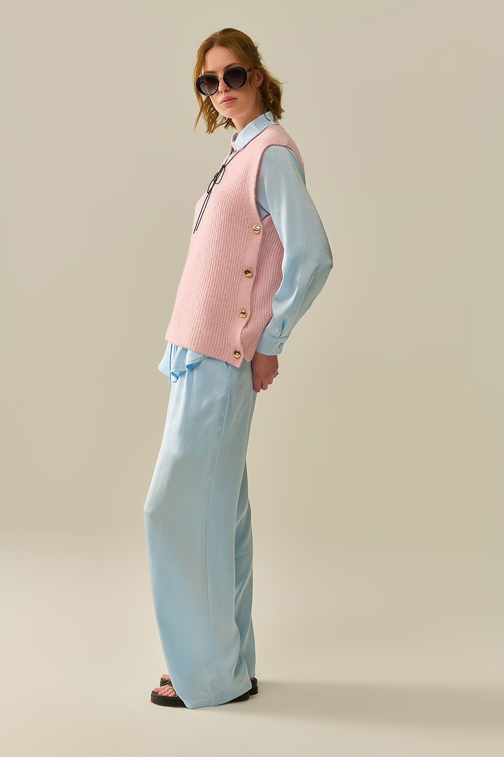 Pink sleeveless sweater with gold buttons