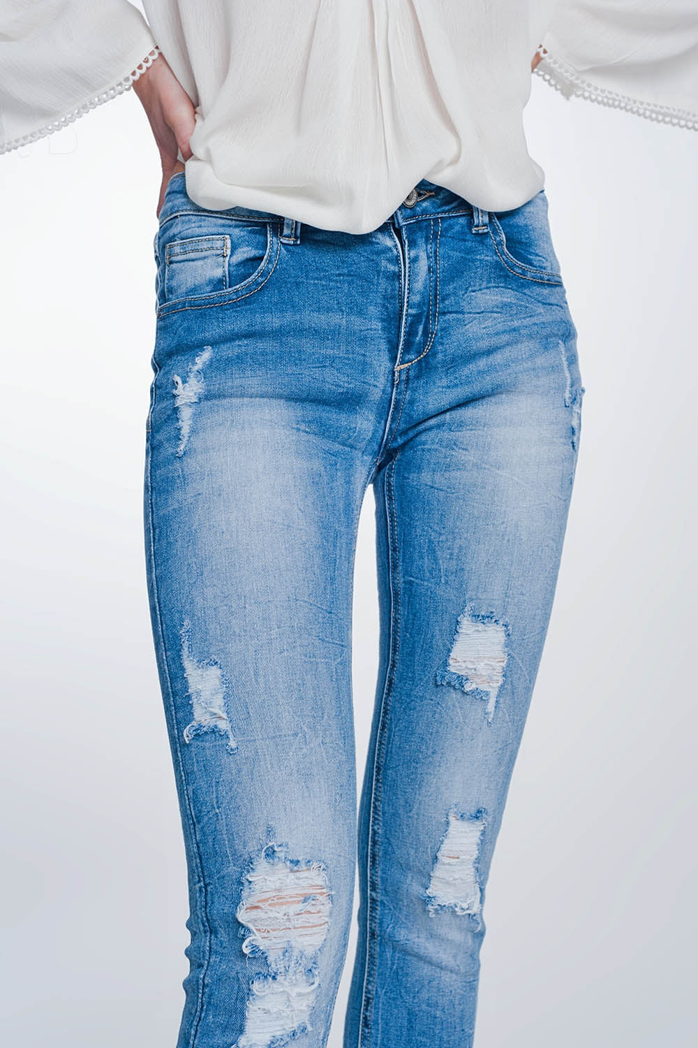 super skinny jeans in vintage mid wash blue with heavy rips