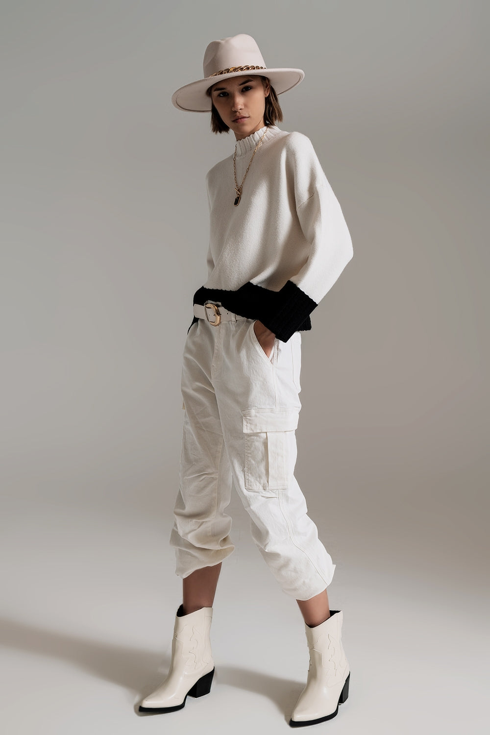 white jumper with black ribbed cuffs and hem