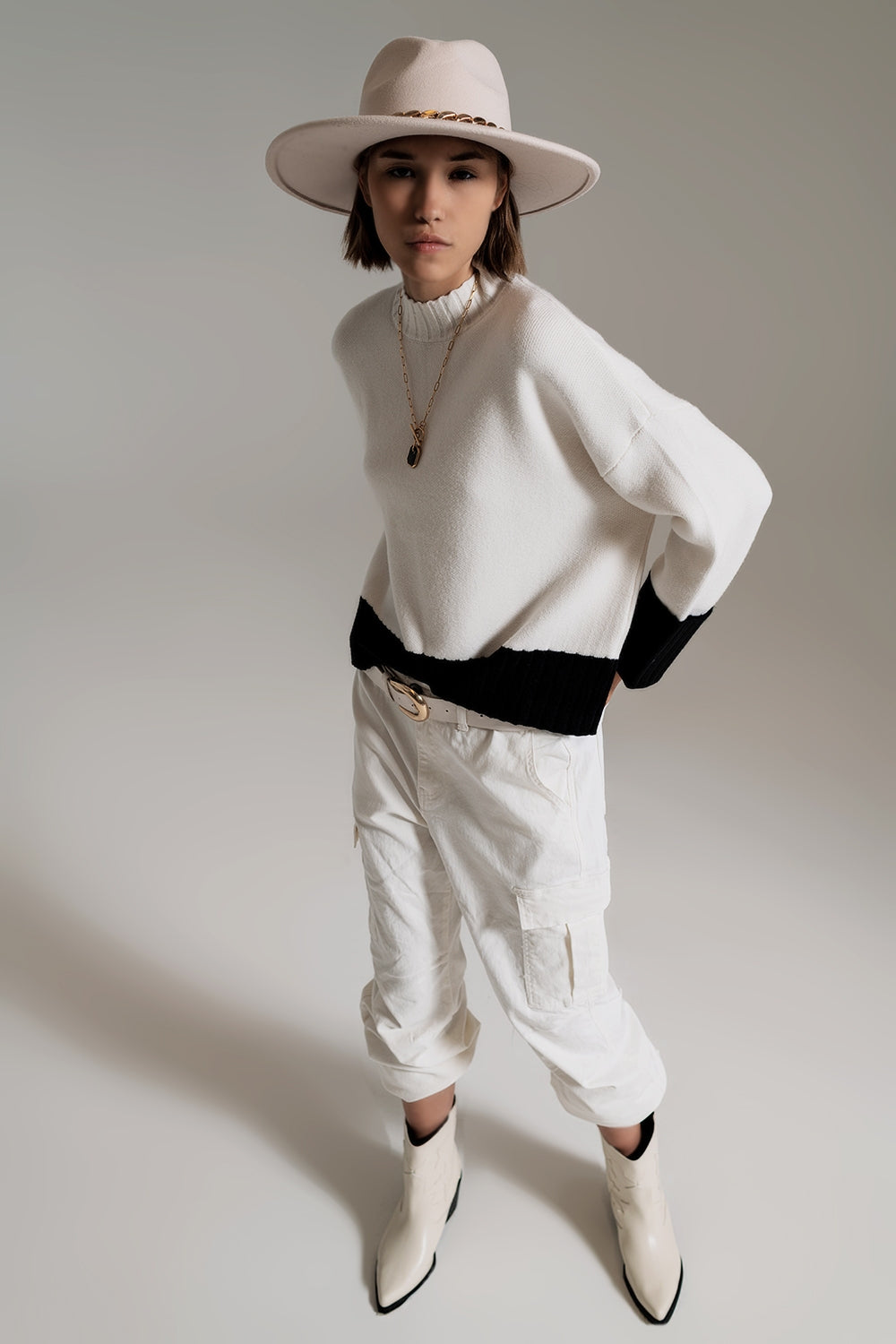 white jumper with black ribbed cuffs and hem