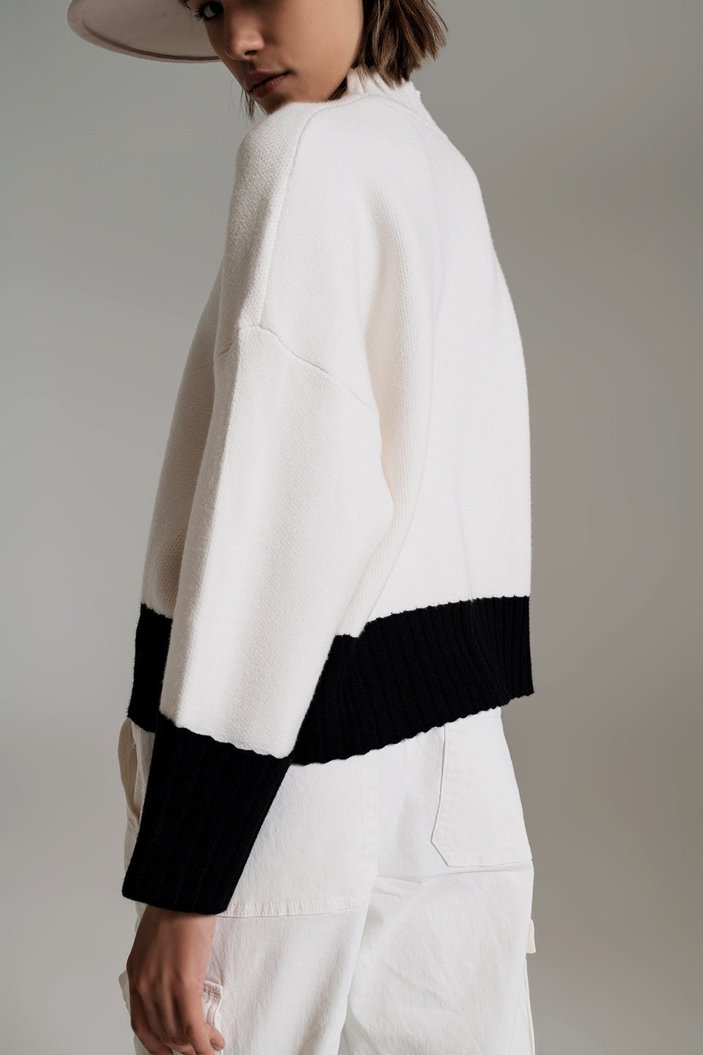 white jumper with black ribbed cuffs and hem