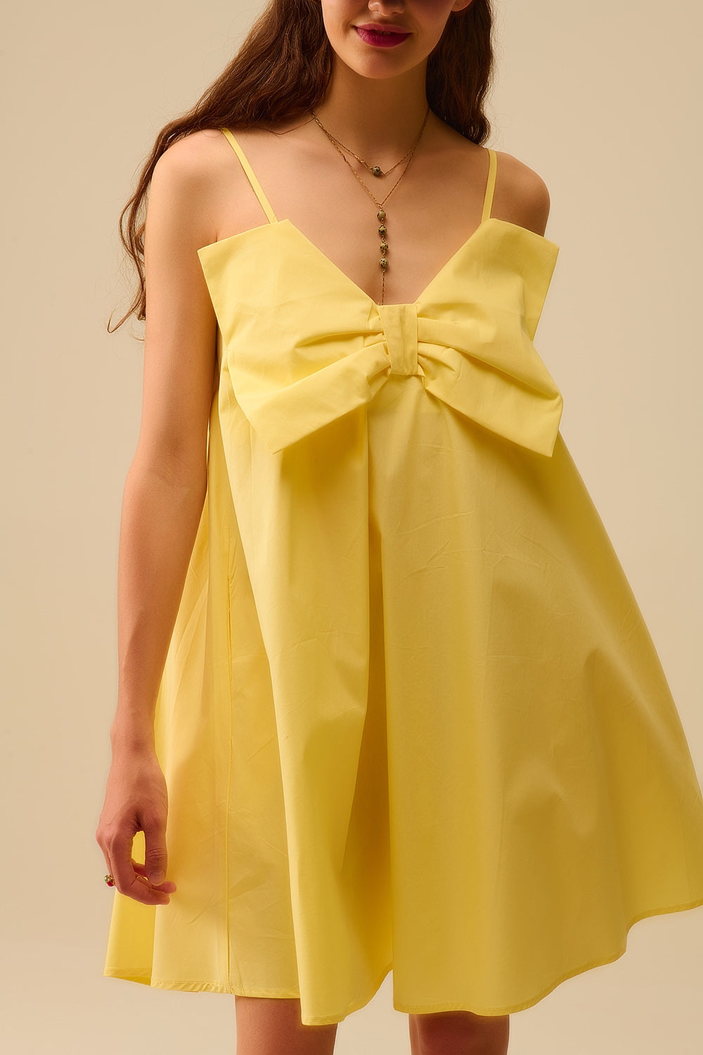 Yellow poplin mini dress with a big bow detail