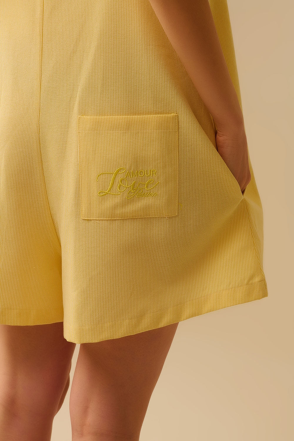 Yellow striped playsuit with shoulder ties and back pocket detail