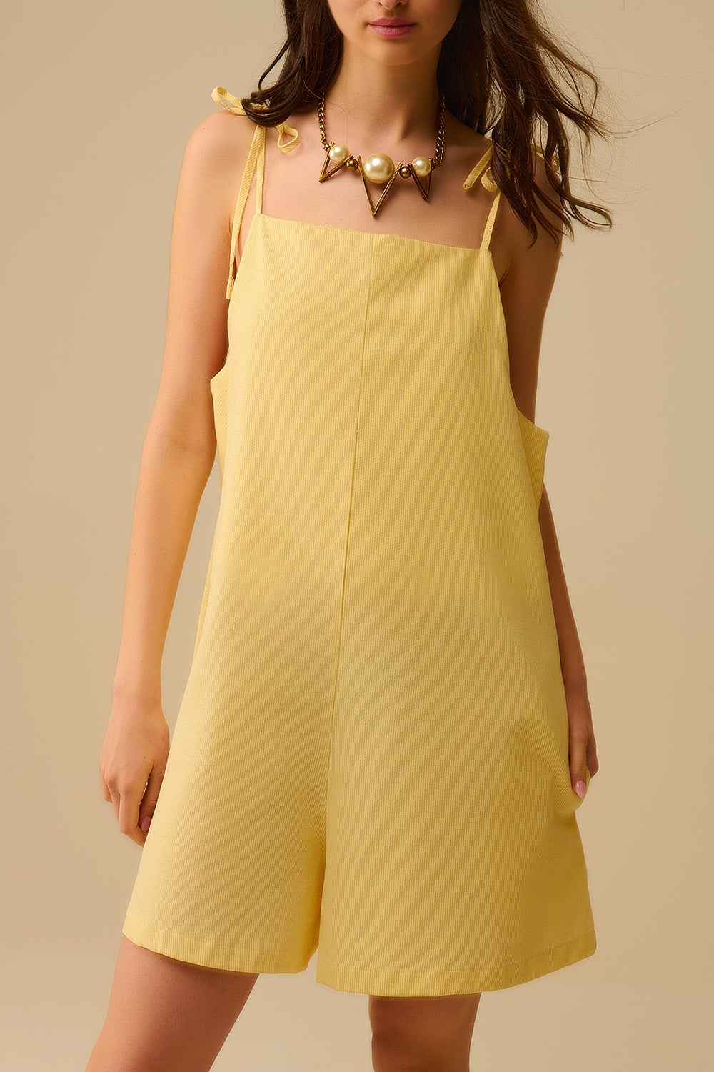 Yellow striped playsuit with shoulder ties and back pocket detail