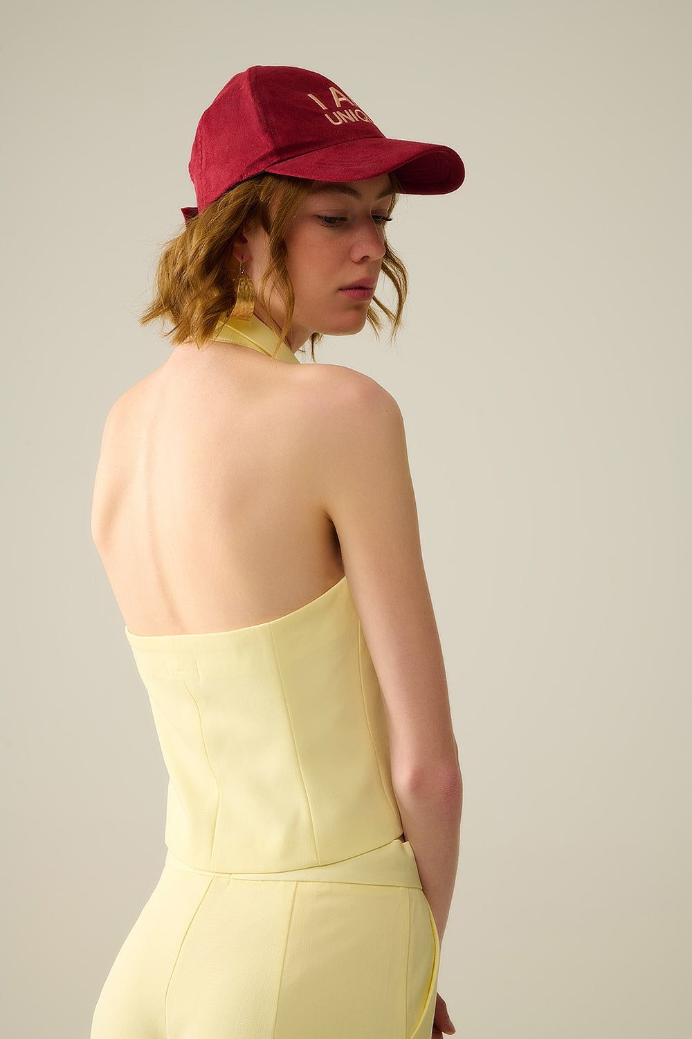 Yellow wrap vest with detailed gold button